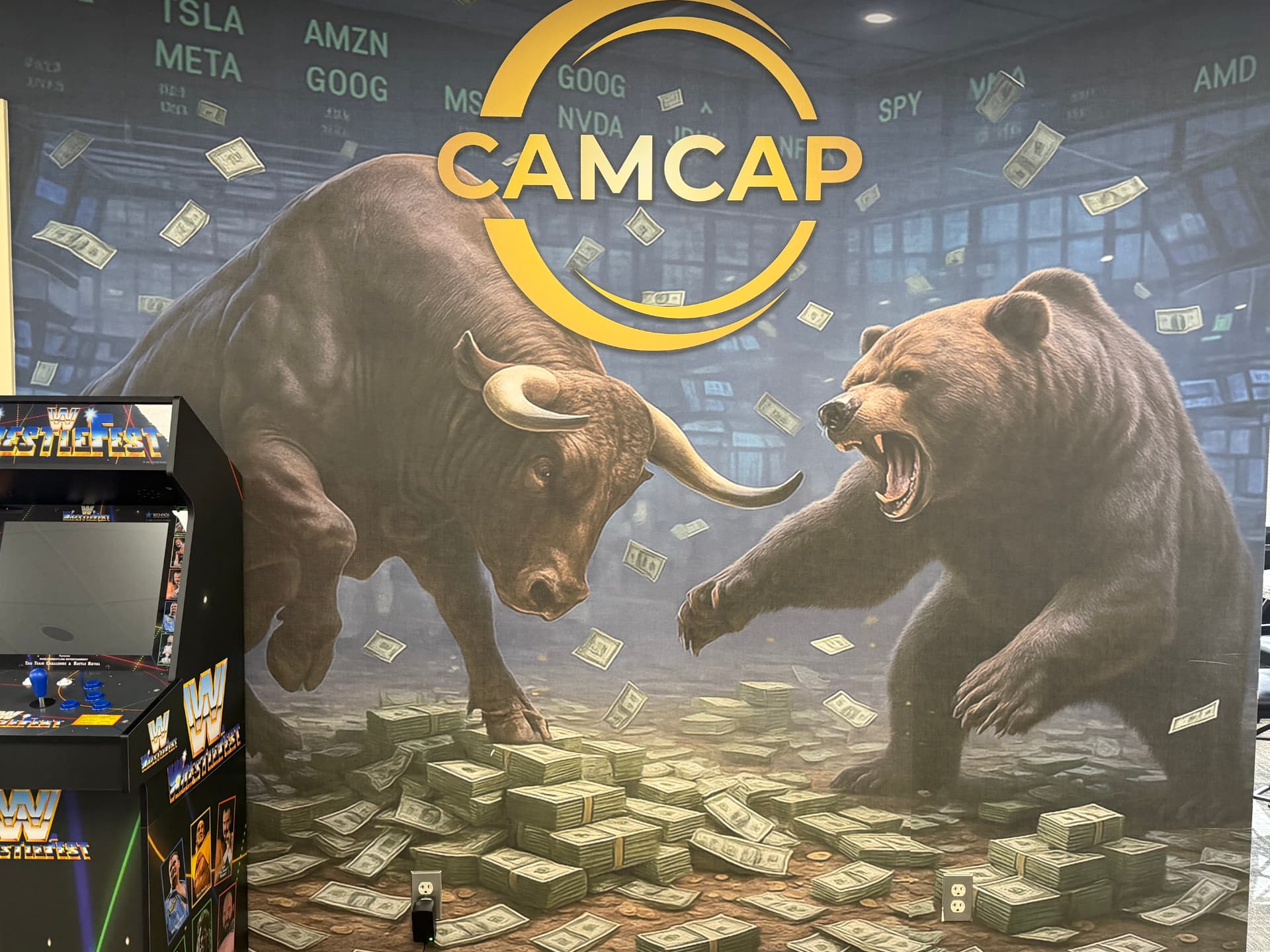 CamCap bull and bear mural with the gold CamCap logo and a retro arcade cabinet in the East Hartford office