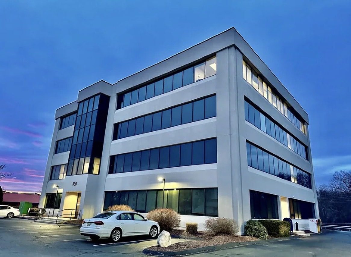 CamCap East Hartford office building at 330 Roberts Street at dusk with lit windows