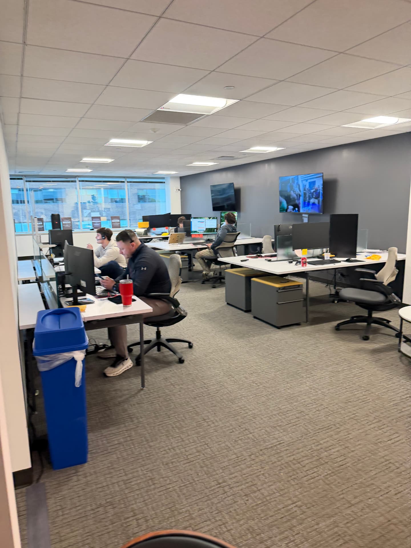 CamCap sales representatives working the phones with headsets on the East Hartford sales floor